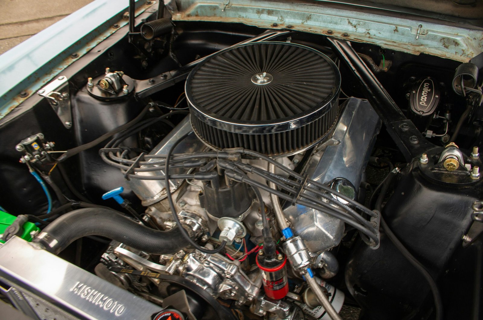 The engine compartment of a car with the hood up