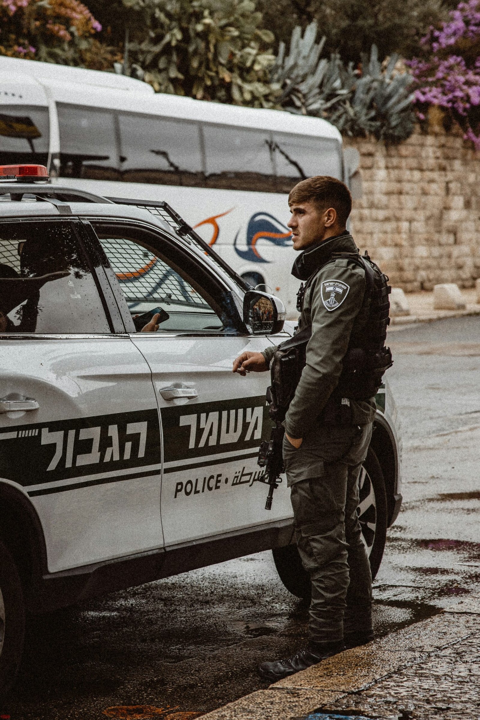 a police officer standing next to a police car